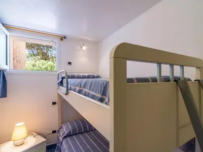 Letto o letti in una camera di Taccarossa casa azzurra