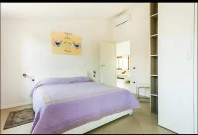 Letto o letti in una camera di B&B su Coccu
