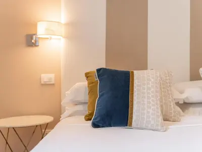 Letto o letti in una camera di PLEY Cagliari Boutique Suites