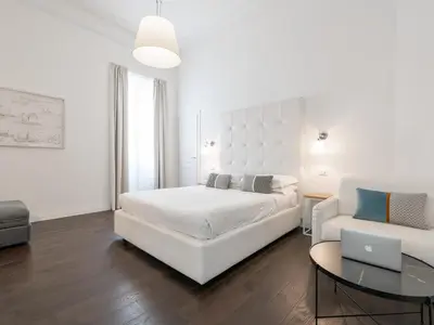 Letto o letti in una camera di PLEY Cagliari Boutique Suites