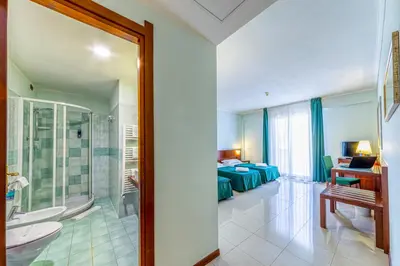 Letto o letti in una camera di Hotel Le Torri
