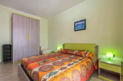 Letto o letti in una camera di L'arcobaleno di Chia CIN IT11101CE