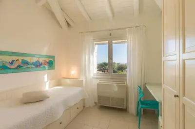 Letto o letti in una camera di Villa Ginestra con piscina e giardino privato a 500 mt dal mare