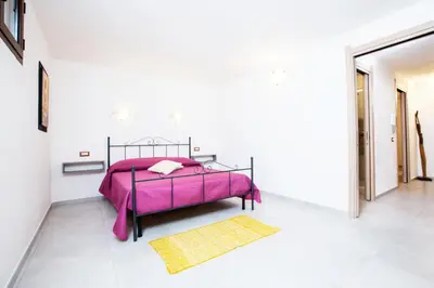 Letto o letti in una camera di Villino Enzo 350 mt Baia di Porto Frailis