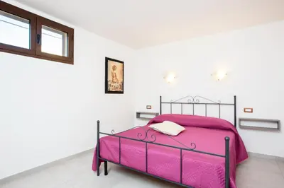 Letto o letti in una camera di Villino Enzo 350 mt Baia di Porto Frailis