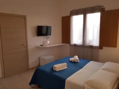 Letto o letti in una camera di B. SINIS