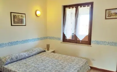 Letto o letti in una camera di Villetta Amare Sardegna
