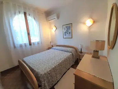Letto o letti in una camera di Nuova Valmar Villa Carta 100 mt mare