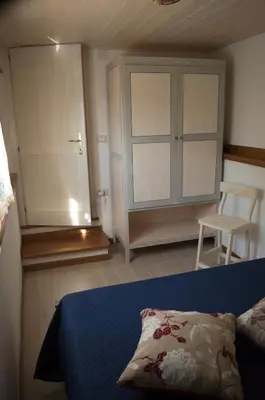 Letto o letti in una camera di Nel verde del Villaggio - Casetta Celeste