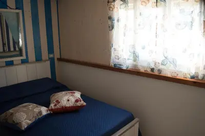 Letto o letti in una camera di Nel verde del Villaggio - Casetta Celeste