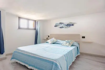 Letto o letti in una camera di Vista Sul Pan di Zucchero - Terrazza vista mare a Nebida