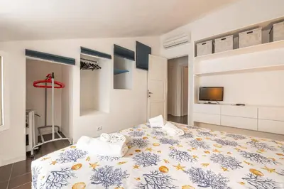 Letto o letti in una camera di Casa Arcobaleno Carloforte