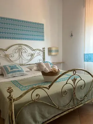 Letto o letti in una camera di ASSUMBRA Casa Vacanze