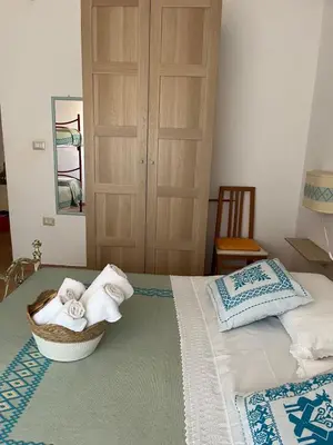 Letto o letti in una camera di ASSUMBRA Casa Vacanze