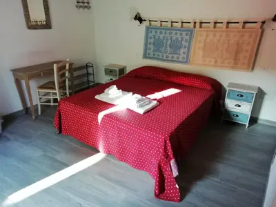 Letto o letti in una camera di S'apposenteddu Affittacamere del Ristorante da Stefano