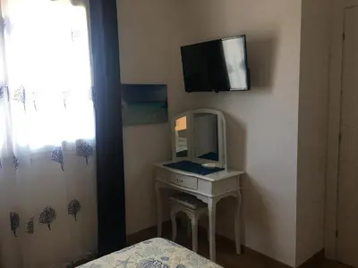 TV o dispositivi per l'intrattenimento presso Blue Sea Rooms Apartment Cagliari