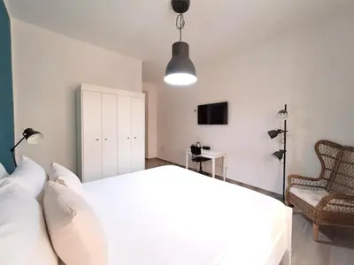 Letto o letti in una camera di Ajana Rooms by Accomodo