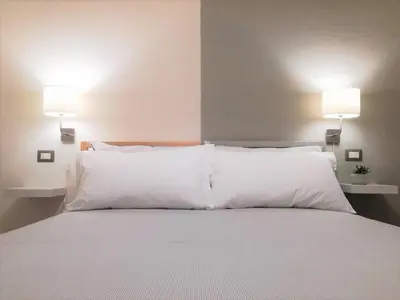 Letto o letti in una camera di Helmi34 - Appartamento dotato di tutti i comfort nel centro di Cagliari