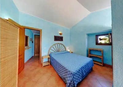 Letto o letti in una camera di Residence Il Borgo di Porto Corallo