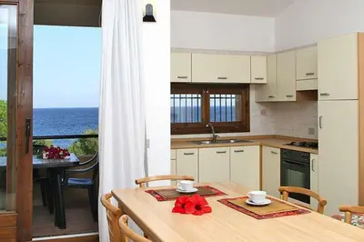Cucina o angolo cottura di Residence Il Borgo di Porto Corallo