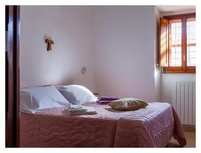 Letto o letti in una camera di Monastero Santa Chiara CpF