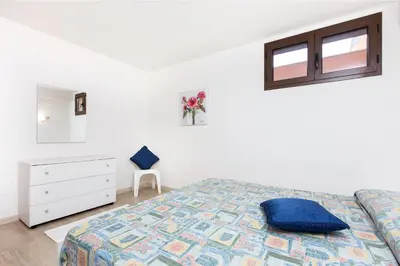 Letto o letti in una camera di Villetta Laura 350 mt Baia di Porto Frailis