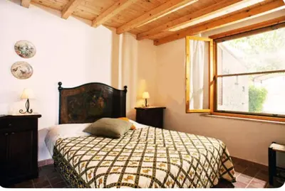 Letto o letti in una camera di VILLETTA CON GRANDE GIARDINO VICINO ALLA SPIAGGIA DI Campus VILLASIMIUS
