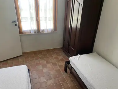 Letto o letti in una camera di VILLETTA CON GRANDE GIARDINO VICINO ALLA SPIAGGIA DI Campus VILLASIMIUS