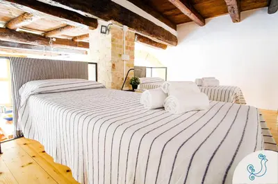 Letto o letti in una camera di Scuderie Reali - Loft in Castello, old town