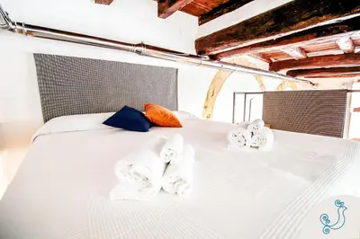 Letto o letti in una camera di Scuderie Reali - Loft in Castello, old town