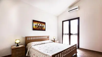 Letto o letti in una camera di Case Vacanza Baia Chia Aiosardegna