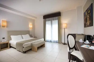 Letto o letti in una camera di Lu' Hotel Carbonia