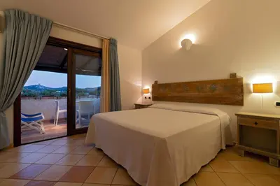 Letto o letti in una camera di Porto Giunco Residence