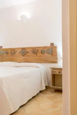 Letto o letti in una camera di Porto Giunco Residence