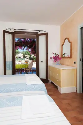 Letto o letti in una camera di S'Incantu Resort