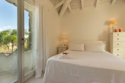 Letto o letti in una camera di Villa Bougainvillea con piscina e giardino privato a pochi passi dal mare
