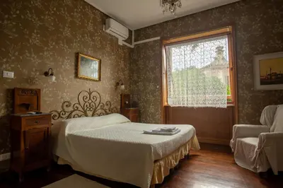Letto o letti in una camera di Locanda dei Buoni e Cattivi