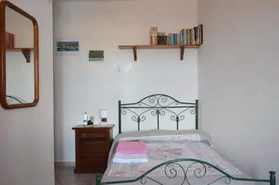 Letto o letti in una camera di B&B Belvedere