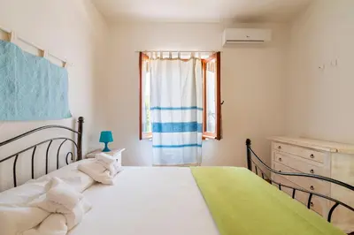 Letto o letti in una camera di Appartamento al mare Via delle Mimose