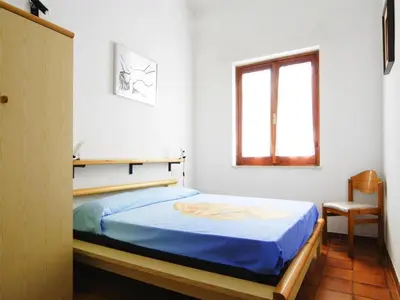 Letto o letti in una camera di Apartments Costa Rei, Costa Rei