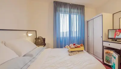Letto o letti in una camera di Hotel Quadrifoglio