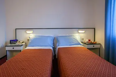 Letto o letti in una camera di Hotel Quadrifoglio