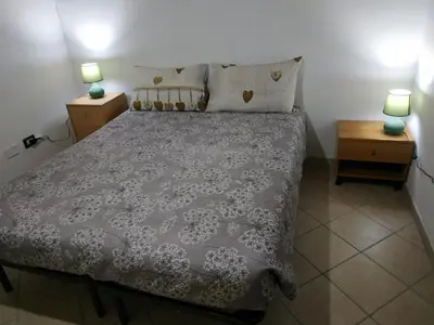 Letto o letti in una camera di COTTAGE SU MERTI country
