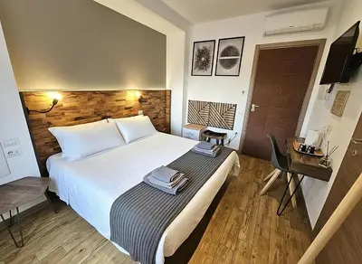 Letto o letti in una camera di ARYA Cagliari