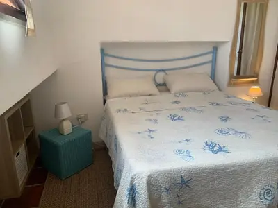 Letto o letti in una camera di Villasimius villetta a 300 mt dalla spiaggia Via Libeccio n 67