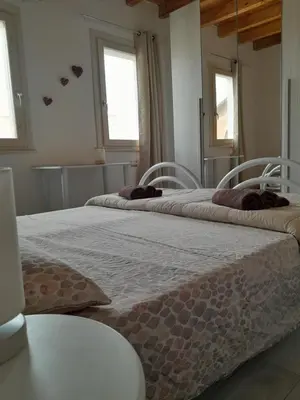 Letto o letti in una camera di Casa Rosa dei Venti