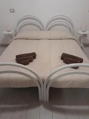 Letto o letti in una camera di Casa Rosa dei Venti