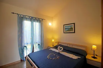 Letto o letti in una camera di Villetta Turagri 38