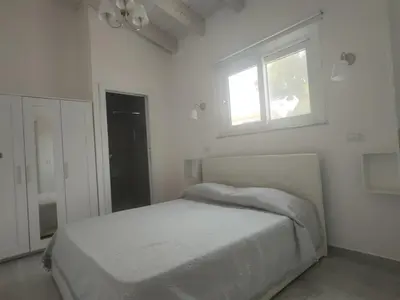 Letto o letti in una camera di IKEBANA VILLAS PORTO PINO BEACH