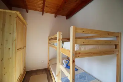 Letto o letti a castello in una camera di TRILOCALE MARGHERITA